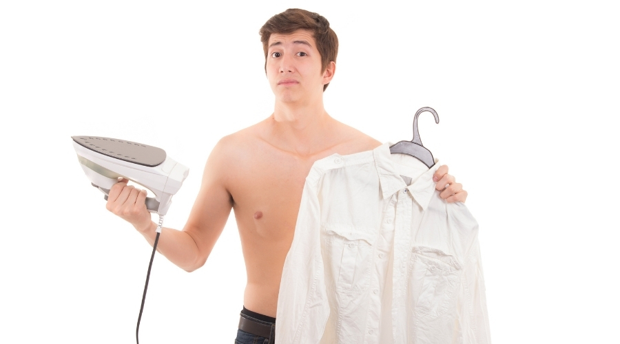 man holding steam iron and shirt